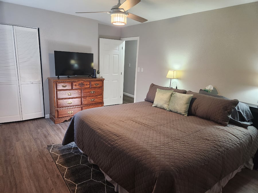 King bedroom with 43" smart tv, dresser and large closet. Bookcase headboard for ease of storing and charging. 20 hangers provided in each closet. Black out shade and curtains provided in all rooms.