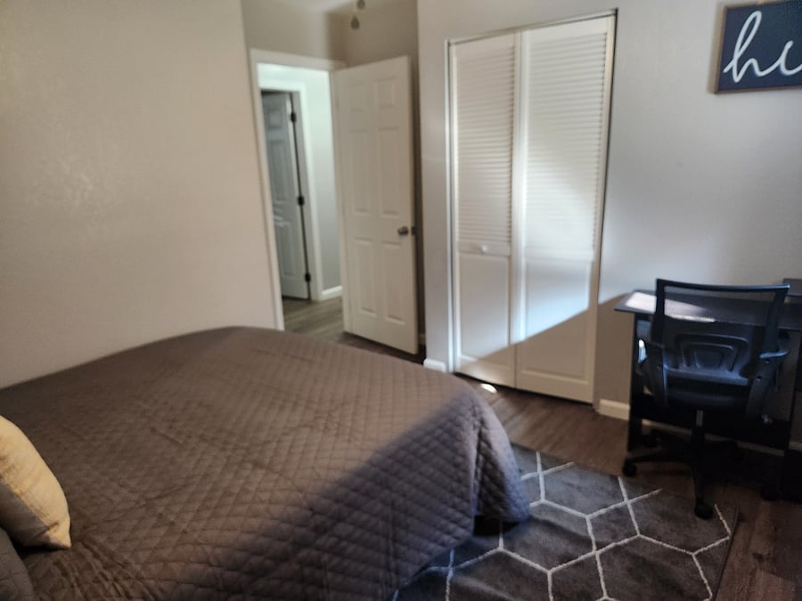 Guest bedroom 1 - queen size bed, large closet & 2nd dedicated work space in the house. Room has dark out shade and curtains.