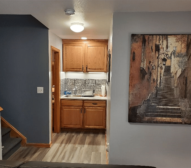 Kitchen sink, bathroom door on left, bedroom door to the right.