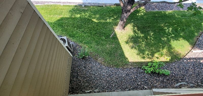 View of the shaded grass area next to private 10 x 13 foot patio (photo taken from above).