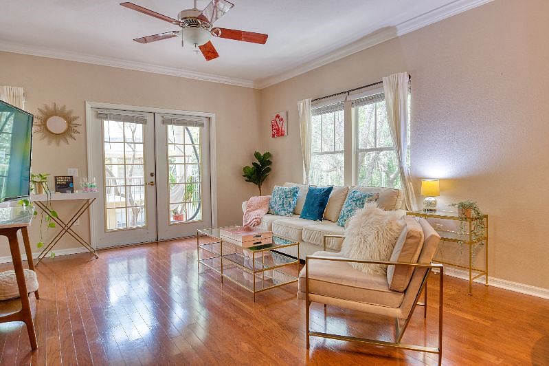 Sunny living room with large windows and comfortable Pottery Barn couch.