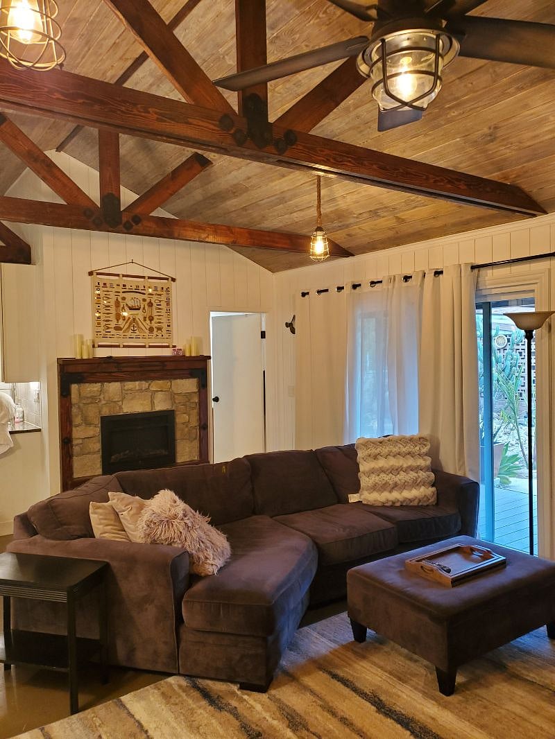 Living room and fireplace. Also shows locking sliding glass door and door into bathroom.