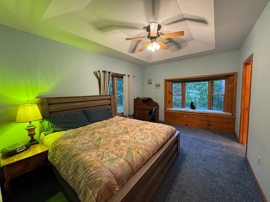 King bed with bedside table/lamp, desk, cushioned window seat, coffered 10 ft ceilings
