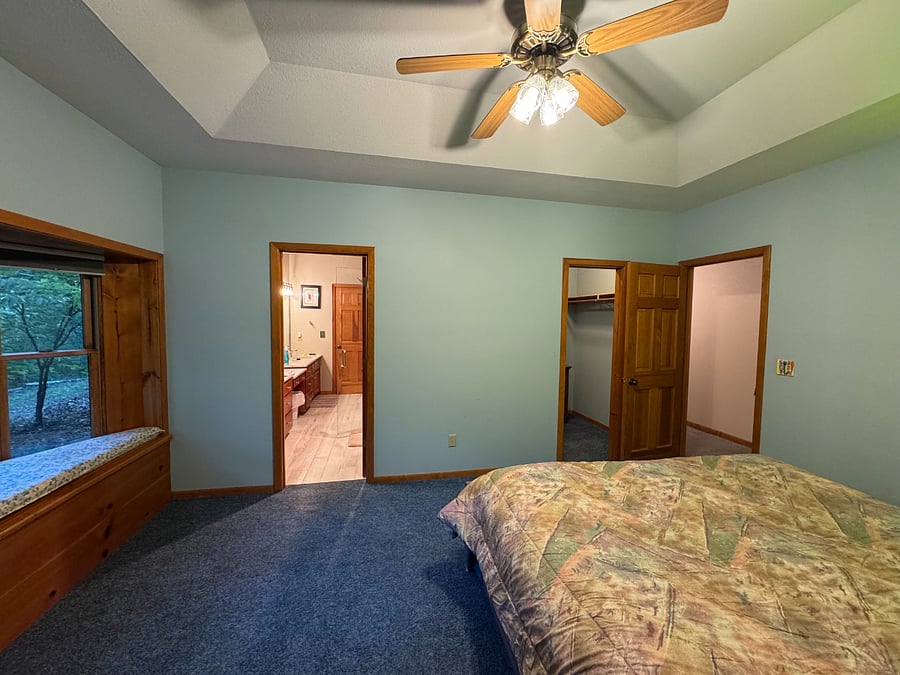 Bedroom with doors to closet and shared bathroom
