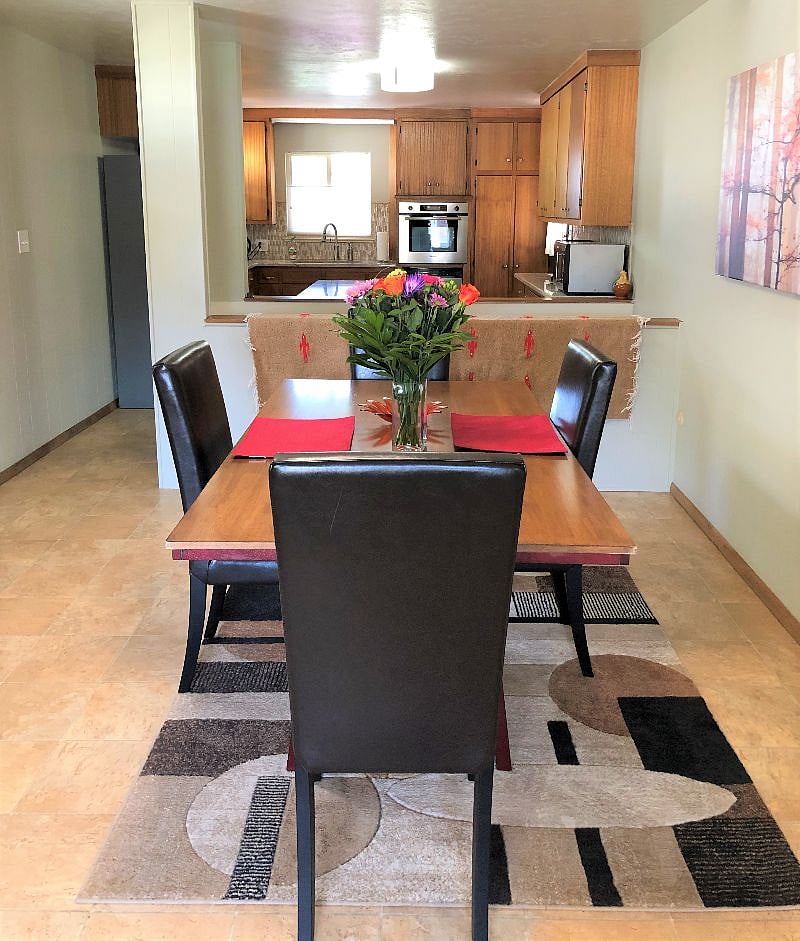 Large dining table with four comfy chairs, the perfect setting for your gourmet meals. Can also be a comfortable second workspace.