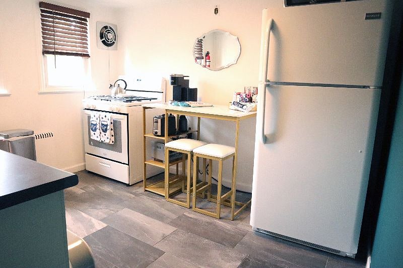Fully stocked kitchen with cooking and baking supplies. Spices, oilve oil, keurig coffee machine, microwave, full size appliances, and both toaster and toaster oven.