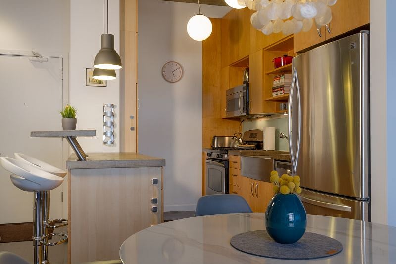 Prepare and enjoy any meal in this fully equipped kitchen with bar-top seating for two, stainless steel appliances, large farmhouse-style sink, glass backsplash, concrete counter tops, plenty of work surface and so much storage.