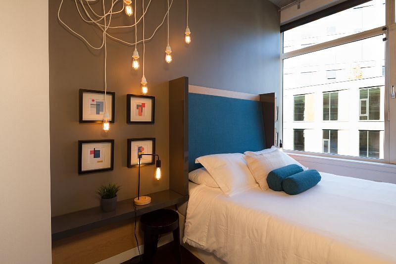 The bedroom has a queen-size bed, as well as built-in headboard and side shelves, closet, window treatments and ceiling fan.