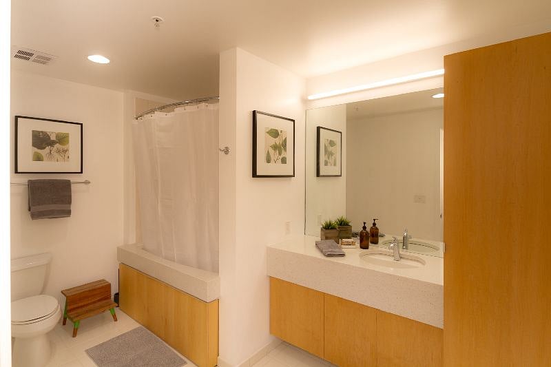 The bathroom vanity is quartz with an undermount sink, large mirror and plenty of counter space and cabinet storage for your personal items.