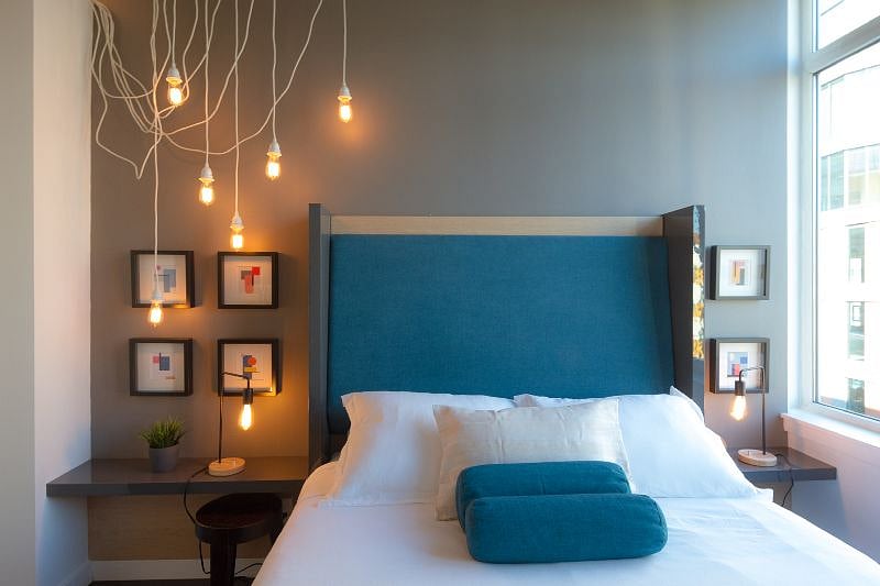 End each day with a great night's sleep in the charmingly styled bedroom featuring soothing tones and soft wood accents, hip lighting, and a bed fit for a queen.