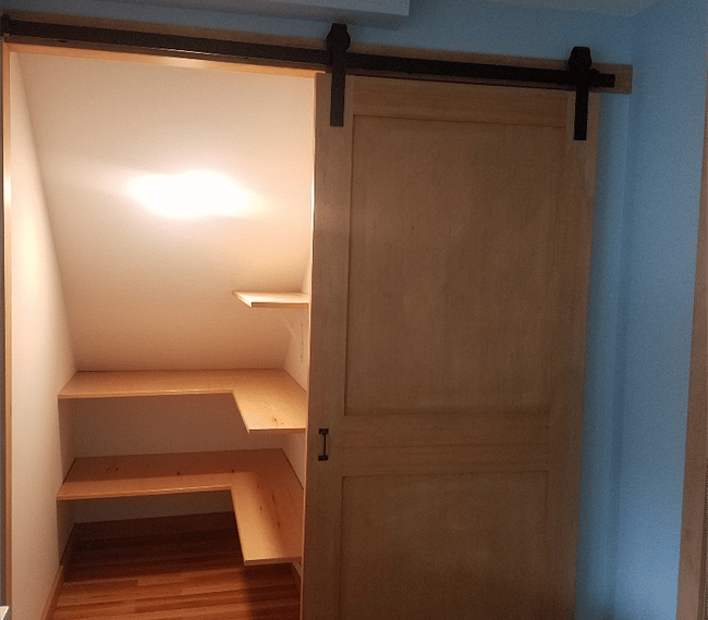 Closet/pantry with sliding barn door.