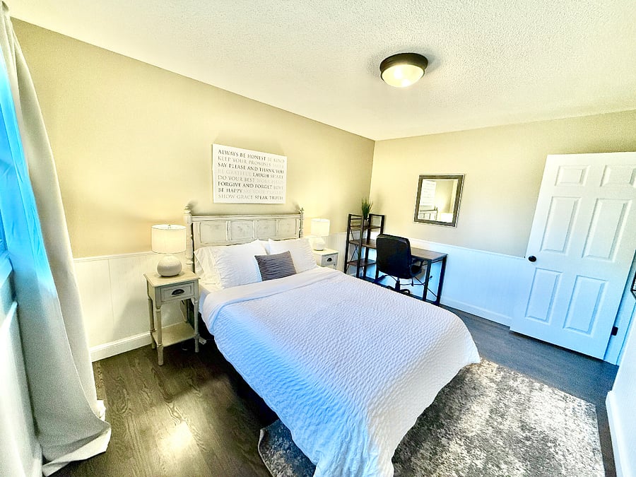 Second bedroom with queen bed and designated work space.