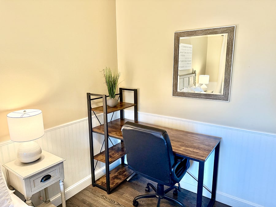 Second bedroom with queen bed and designated work space.