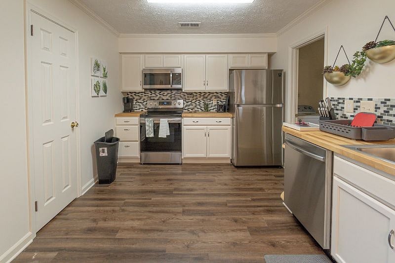 Modern stainless-steel appliances and stylish design define the kitchen