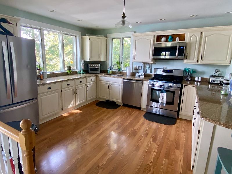 Fully equipped kitchen with granite counter tops, dishwasher, gas range and dining island with room for four.