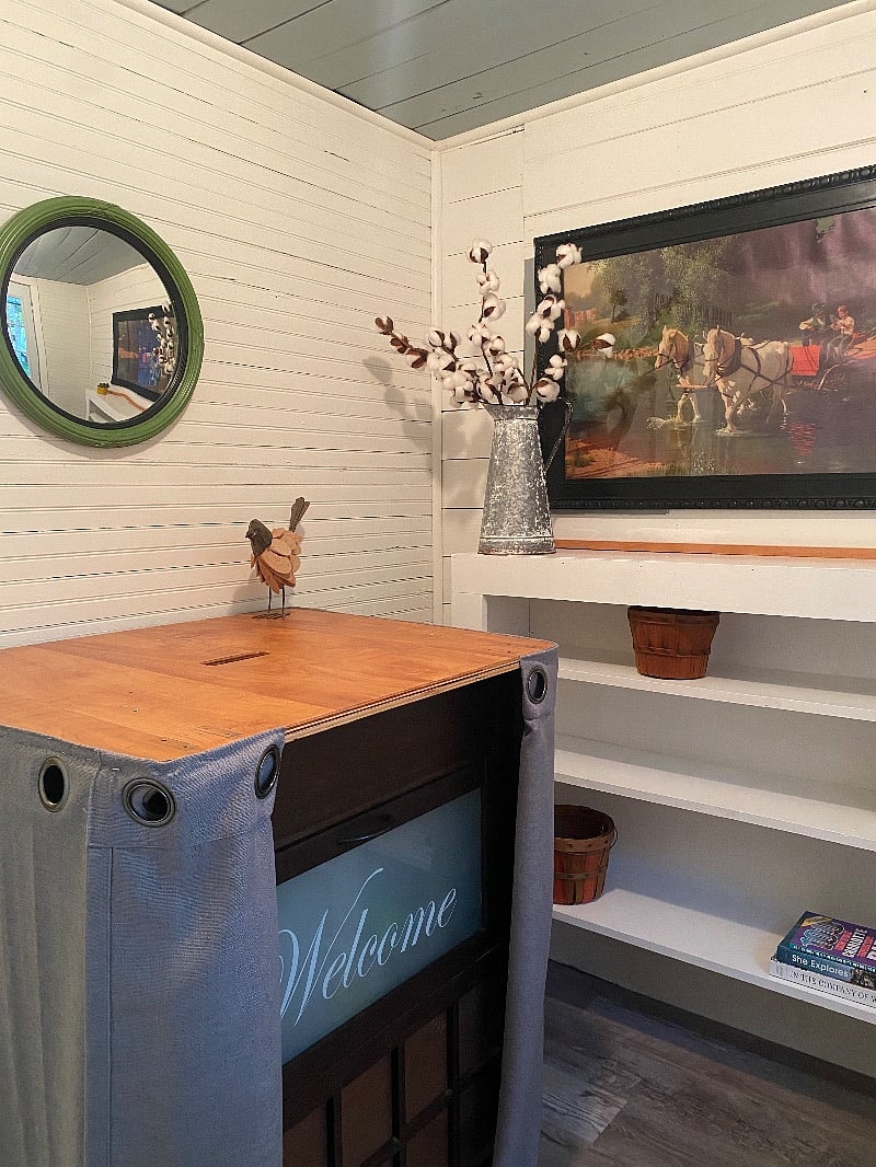 This is your foyer area which features shelves and suitcase storage.