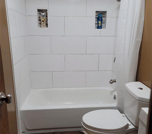 Newly Remodeled Hall Bathroom with Tile shower surround, new bathtub, new low flow toilet and new vanity.