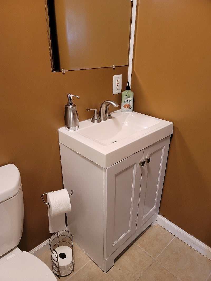 Newly remodeled Master Bathroom with new glistening white tile shower surround and sliding glass doors with adjustable handheld shower head, tile floor, low flow toilet and new vanity.