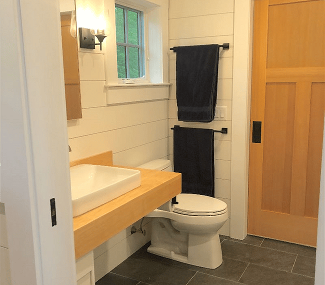 Downstairs bath has two sliding pocket doors.