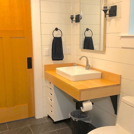 Sliding door to left of vanity leads to mud room.