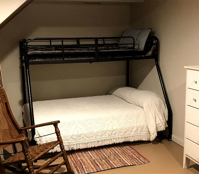 Sleeping or storage alcove to left of hearth and full sized bed....