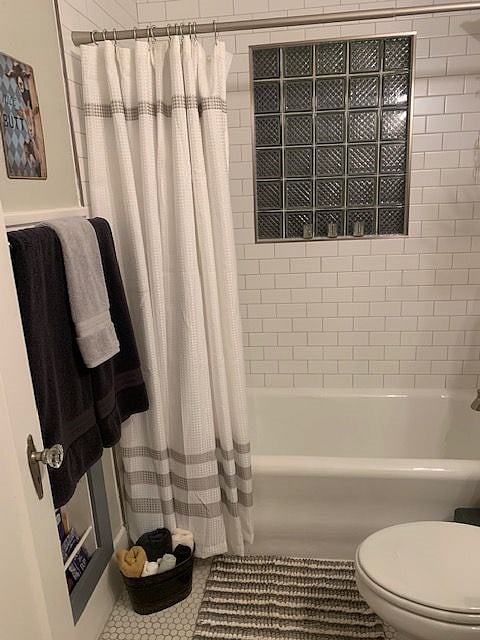 original refinished bathtub and penny tile floors