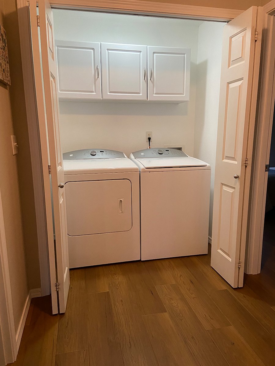 Indoor laundry with washer/dryer and storage