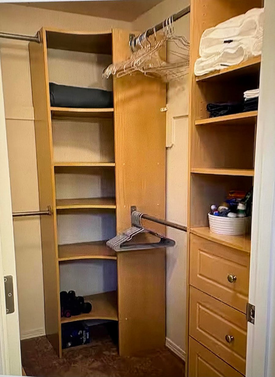 Spacious Master Bedroom walk-in closet with storage cabinets and drawers