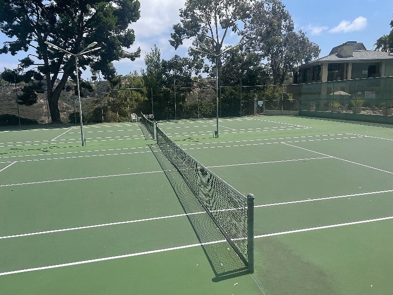 two lit tennis courts
