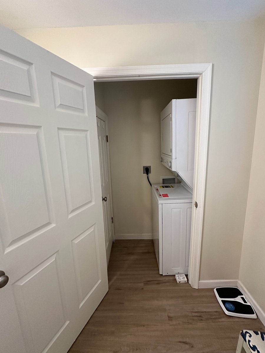 Stackable Washer/Dryer adjacent to bathroom