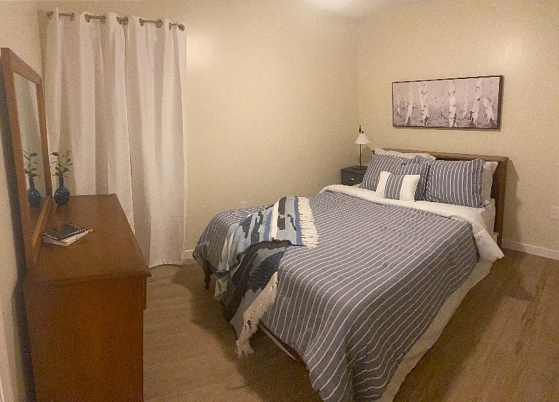 Queen bedroom with closet and chest and dresser drawers