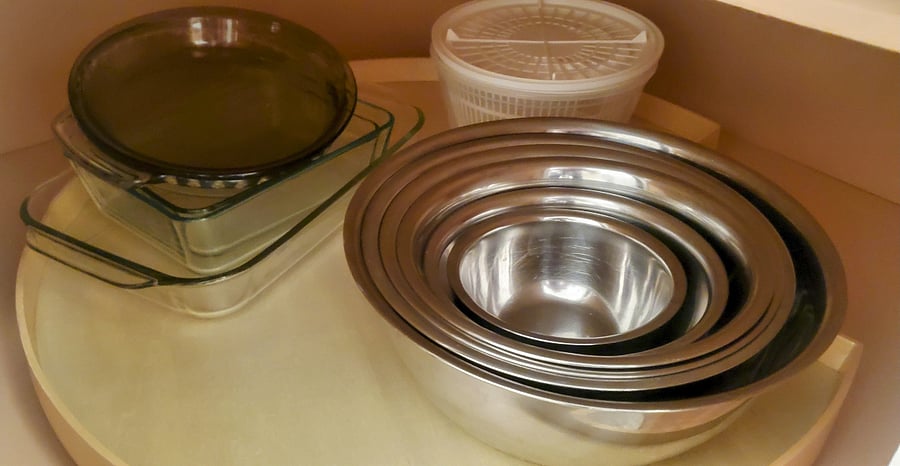 Many casserole dishes, stainless bowls and salad spinner