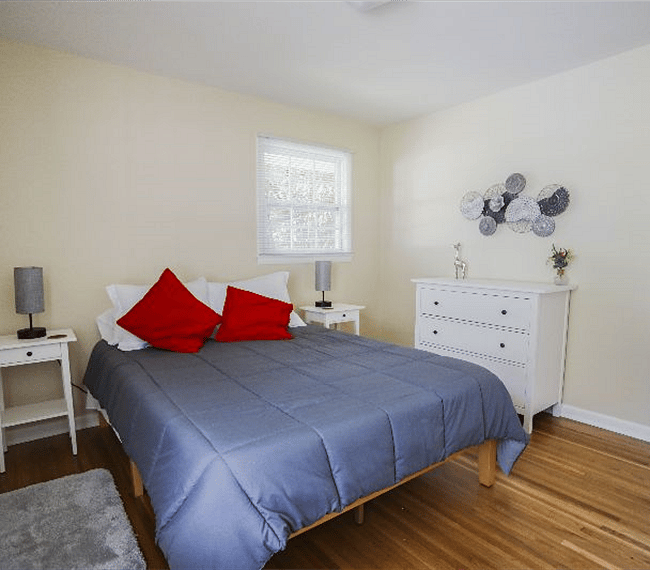 Bedroom 2 folding door closet with laundry basket and fan
