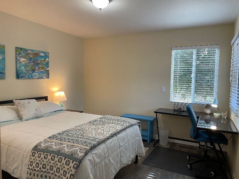 Spacious and peaceful bedroom with new furnishings.