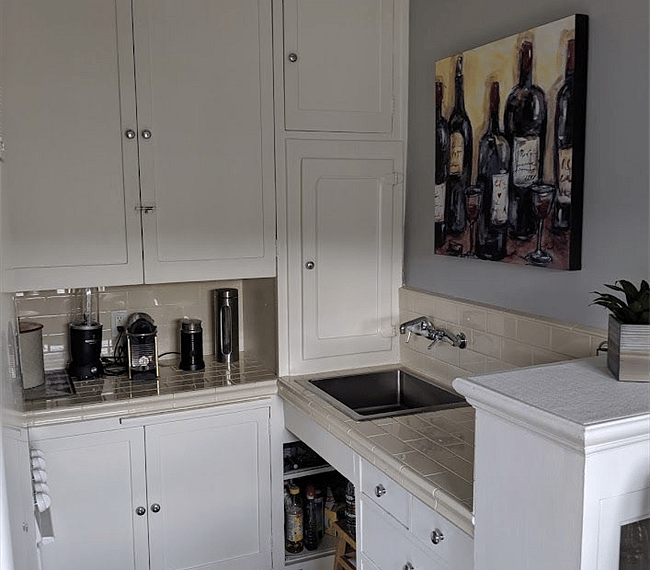 Kitchen with a full-size refrigerator and 4 burner gas stove.