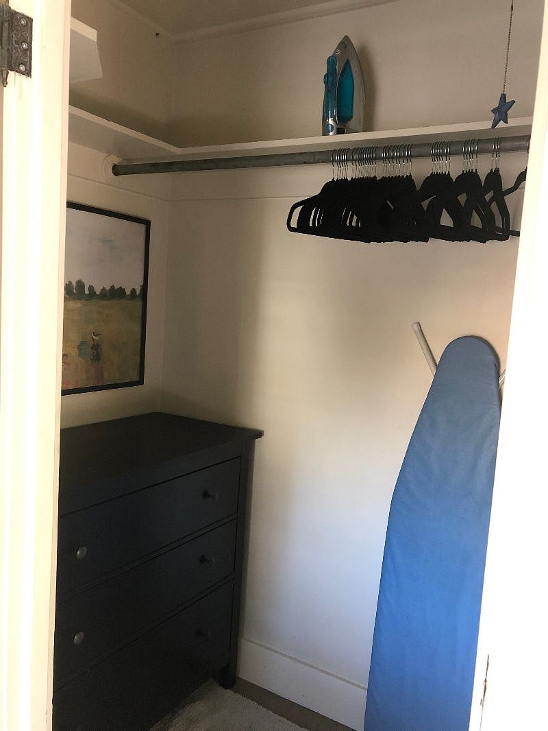 The closet is 4' x 9' and contains a dresser, iron and ironing board,and plenty of hangers.