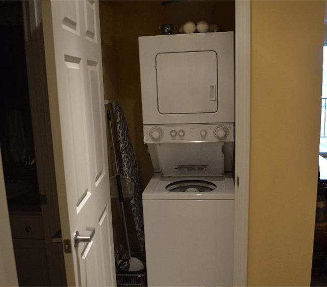 Washer and dryer, ironing board, iron, broom, and mop.  Next to second bathroom. 
