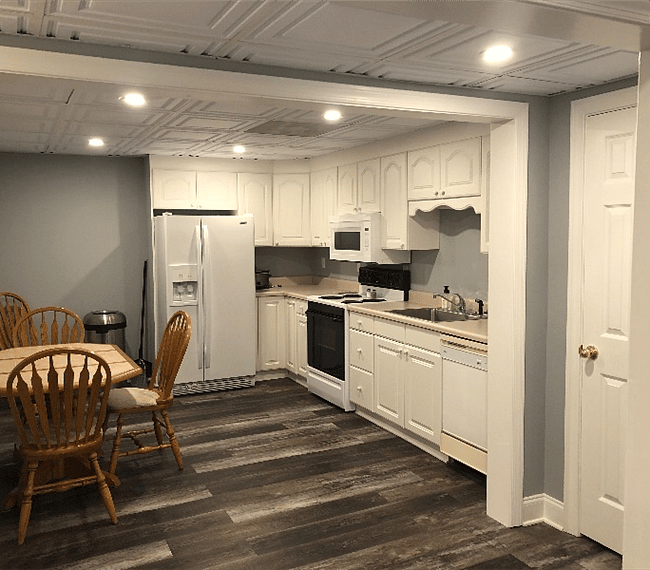 Looking into the kitchen from the living room, storage closet on right.
Vacuum, mop/bucket, and small ironing board included.