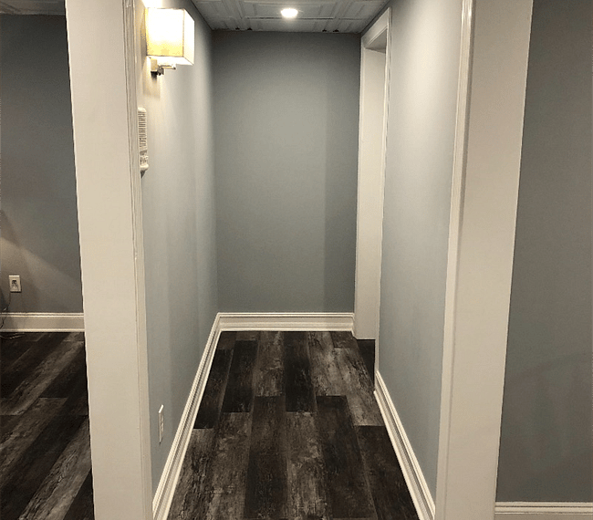 Hallway from kitchen to bedroom, bathroom, and laundry nook.
