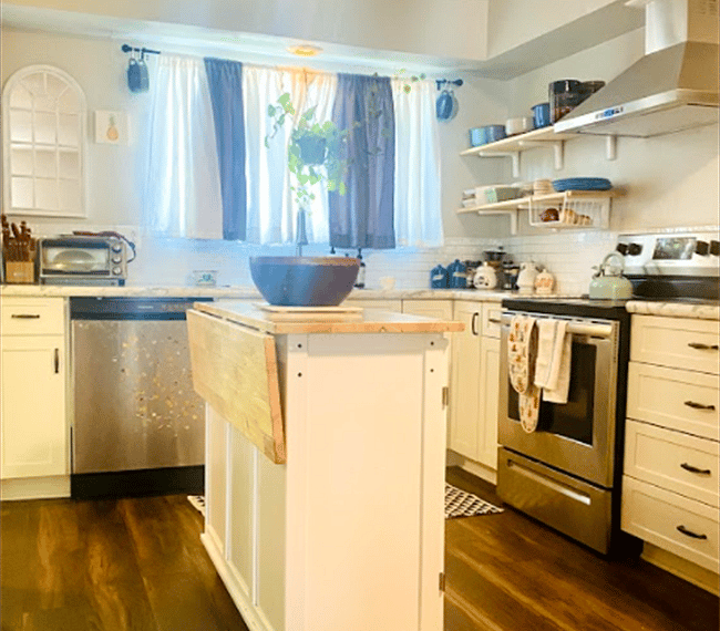 Fully stocked Kitchen, island is on wheels and can be moved around as needed.