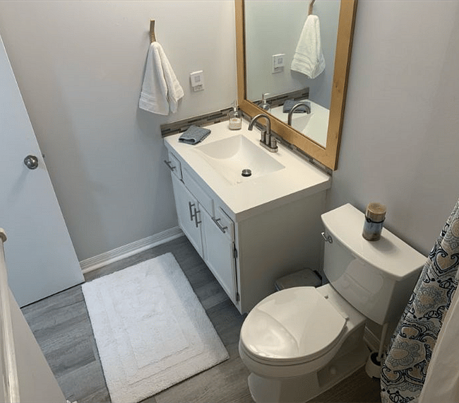 Wash up in the guest bathroom with updated toilet and vanity. 
(bathtub and shower)