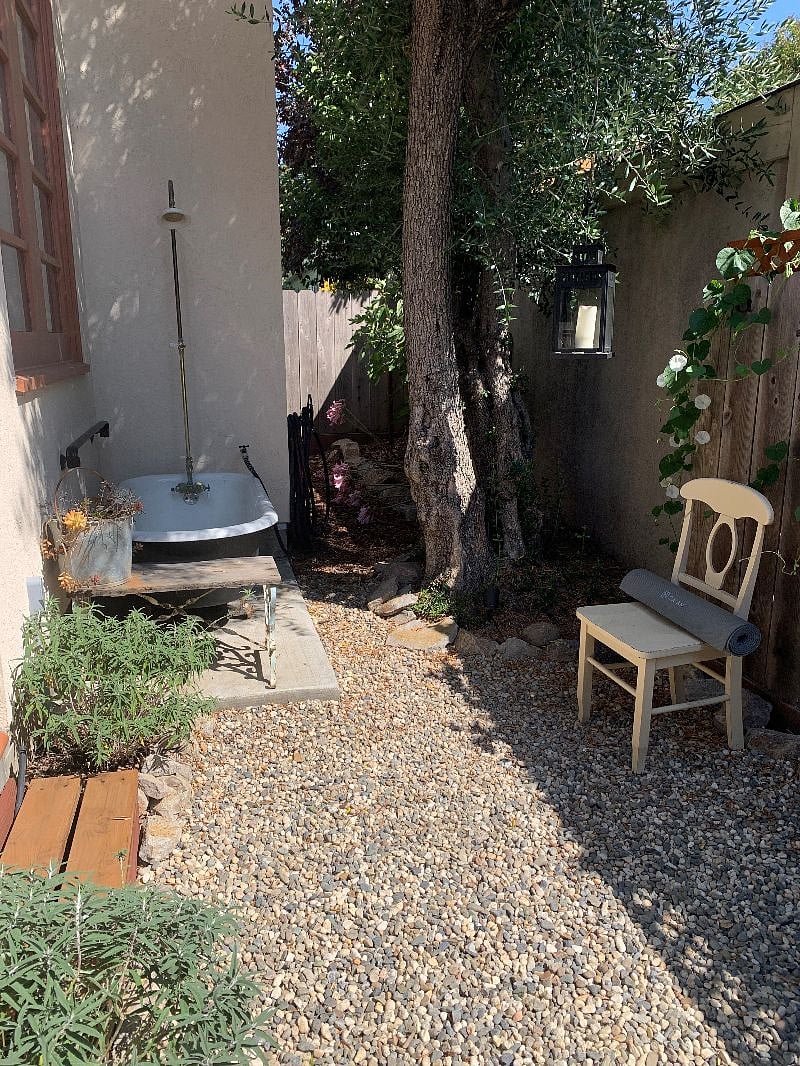 Outdoor soaking tub and shower has hot and cold water.
