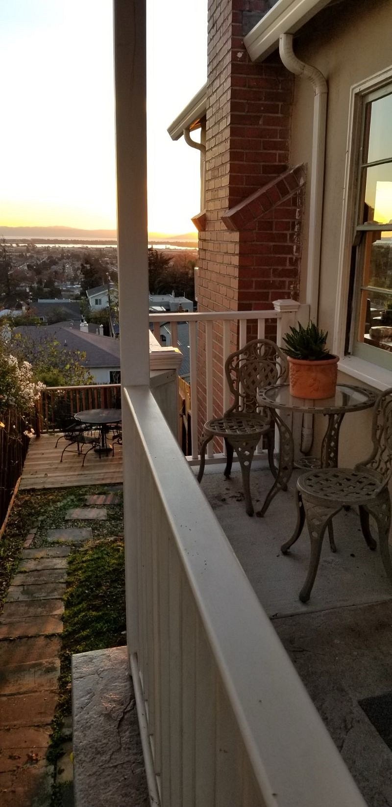 Your 2 private sitting areas, porch and small yard with deck below