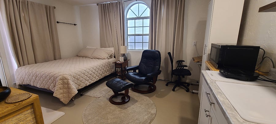 Queen size bed and comfy reclining chair with ottoman
