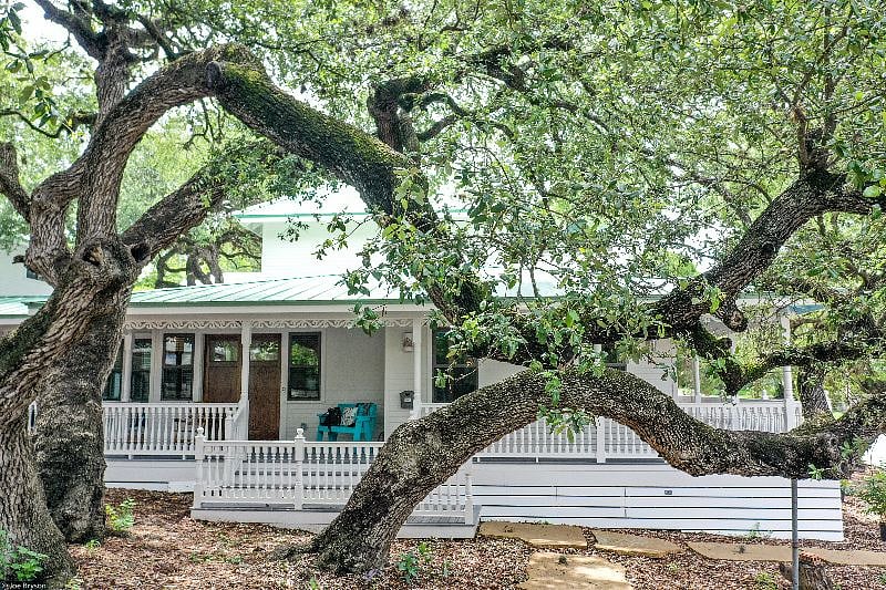 This wrap around porch has 3 different sitting and social areas. Front porch to street has colorful rocking chairs.