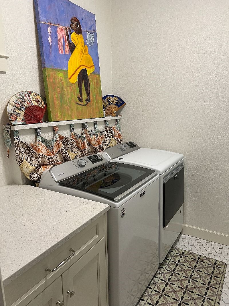 Latest greatest Maytag appliances. Artful laundry area.