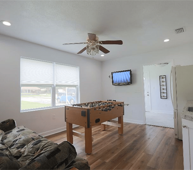 Game room with television, foosball, and bonus kitchenette.