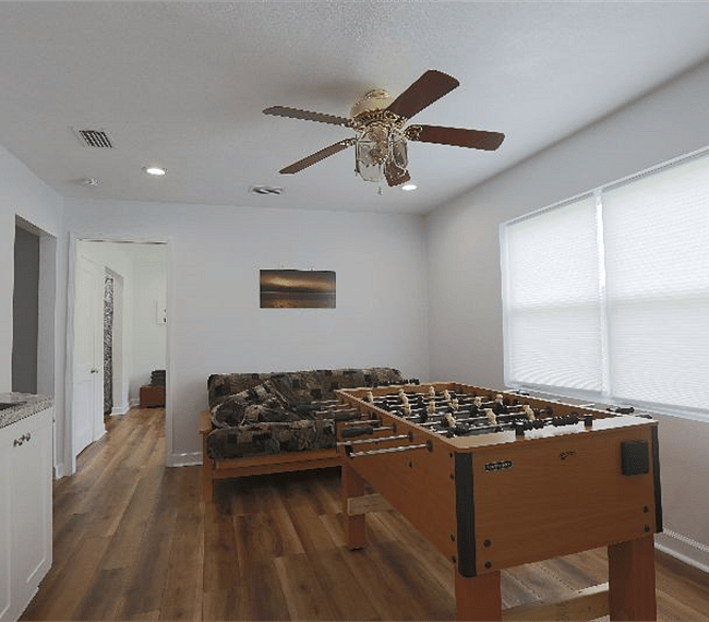 Game room with television, foosball, and bonus kitchenette.
