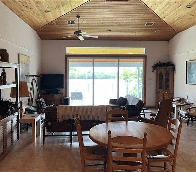 Great room with soaring ceiling and view toward the river.