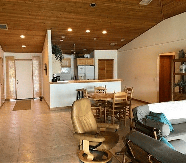 Great room with view toward eating area, kitchen, and front door.